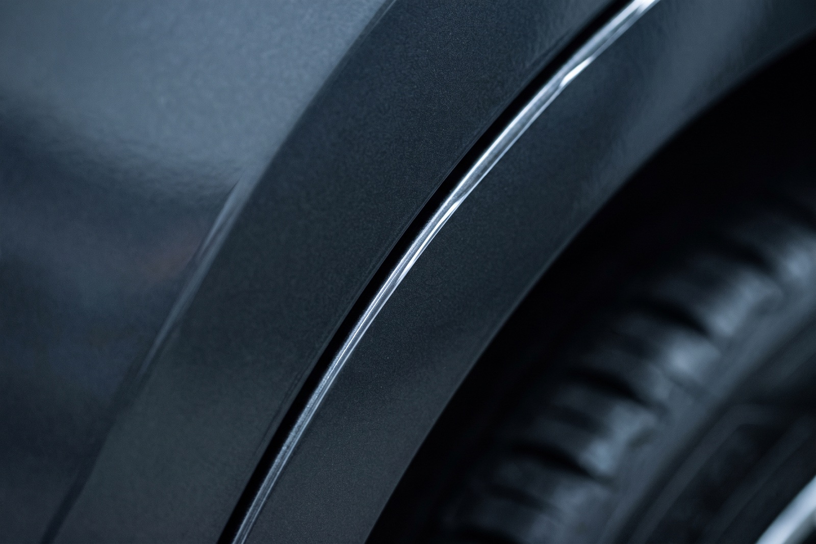 T-Shield PPF film edge — virtually invisible on dark car paintwork